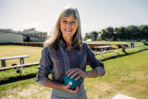 A woman smiling and holding a spherical object